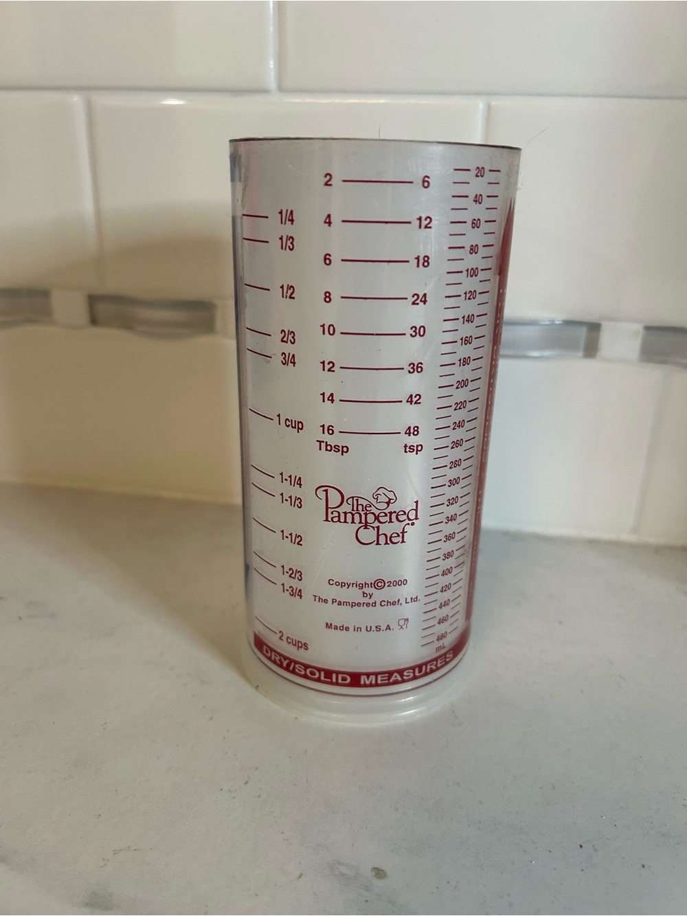 The Pampered Chef Clear Measuring Cup with Red Markings and Logo